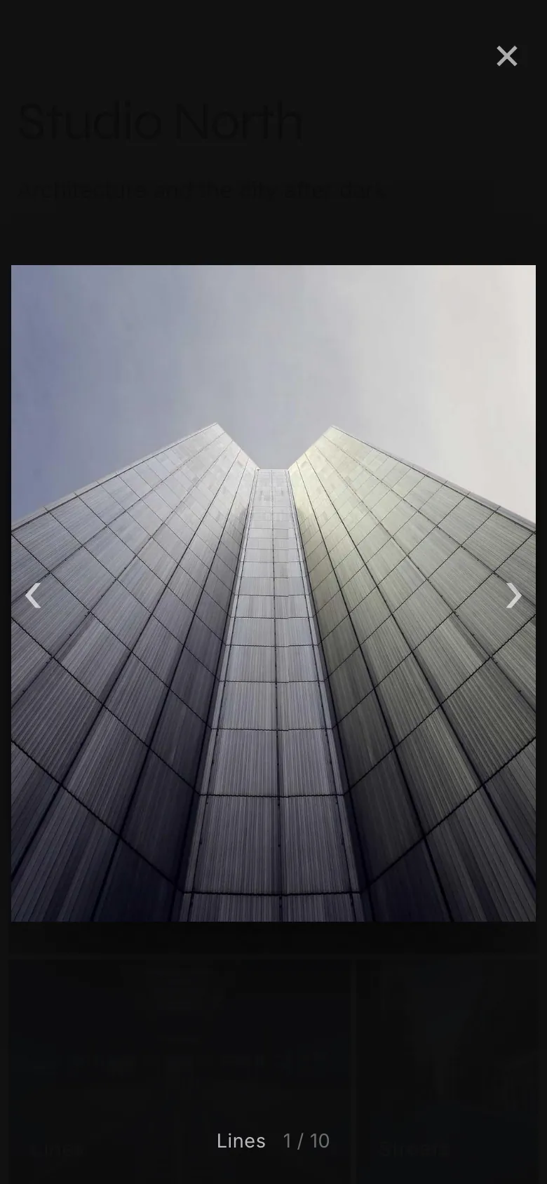 The photo viewer on a phone: one tall building photo, full screen, with arrows and a close button.